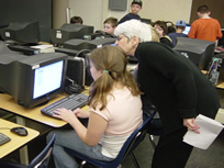 Mrs Raker assists student at computer