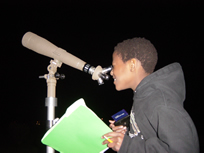 Student looking through telescope